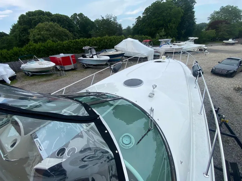 Slide: The Image of 2001 Wellcraft 45 Excalibur boat in storage yard with other vessels and vehicles. - 25