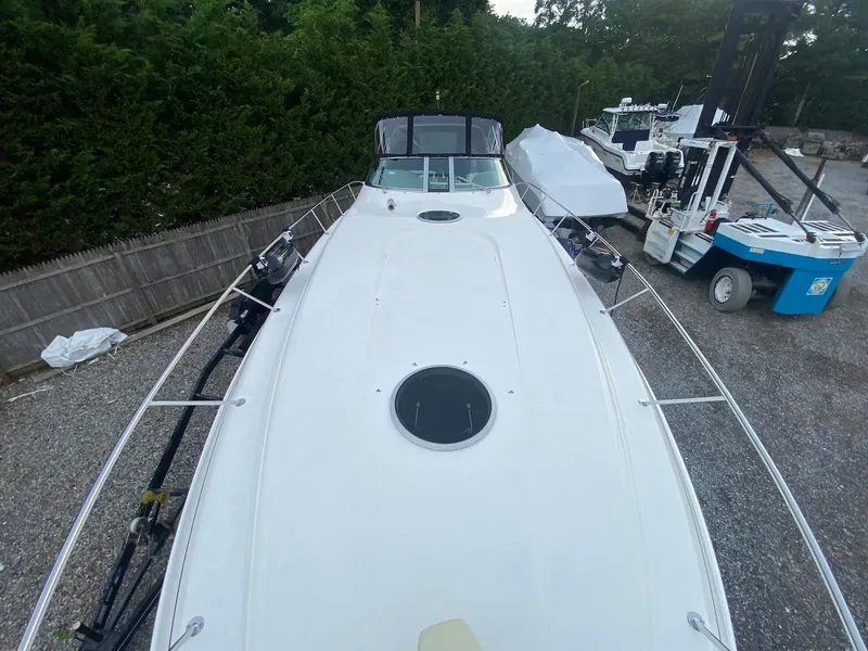 Slide: The Image of 2001 Wellcraft 45 Excalibur boat on gravel, surrounded by trees and equipment. - 26