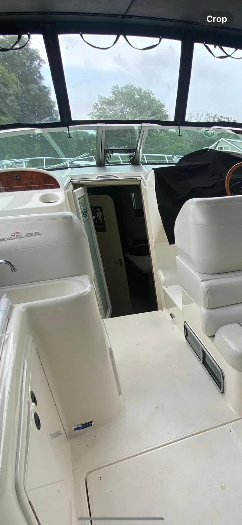 Slide: The Image of 2001 Wellcraft 45 Excalibur boat interior with white seating and helm. - 32