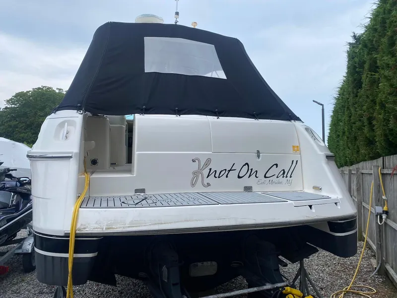 Slide: The Image of 2001 Wellcraft 45 Excalibur boat named "Knot On Call" docked, rear view. - 4