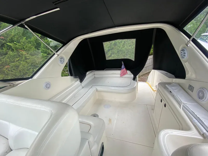 Slide: The Image of Interior of 2001 Wellcraft 45 Excalibur boat with white seating and American flag. - 6