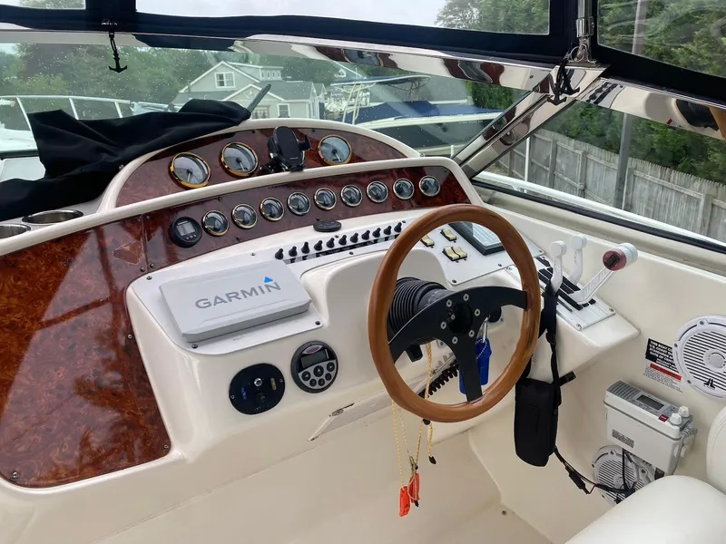 Slide: The Image of 2001 Wellcraft 45 Excalibur boat dashboard with Garmin navigation system and wooden steering wheel. - 9
