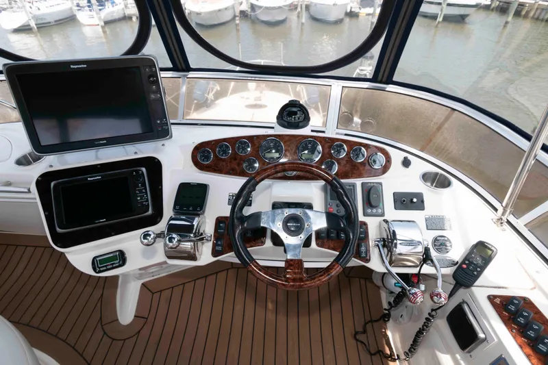 Slide: The Image of Control panel of a 2006 Meridian 341 Sedan yacht with navigation equipment and steering wheel. - 11