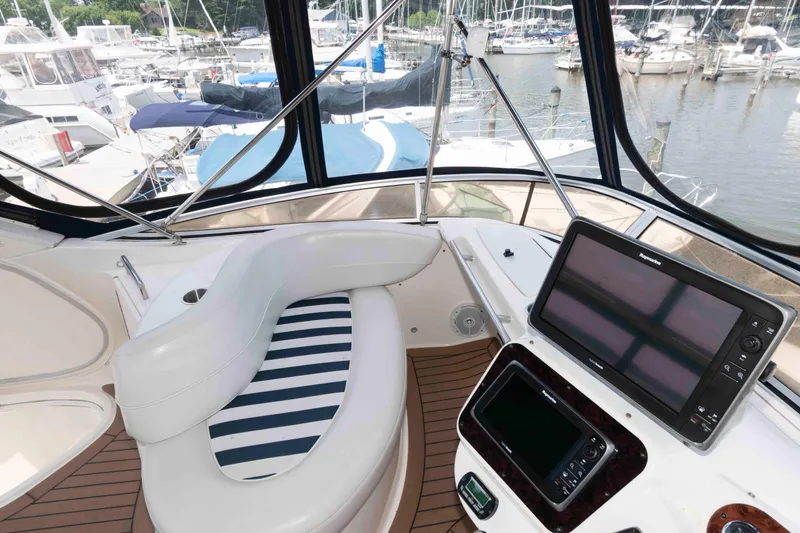 Slide: The Image of Cockpit of 2006 Meridian 341 Sedan yacht with navigation equipment and marina view. - 12