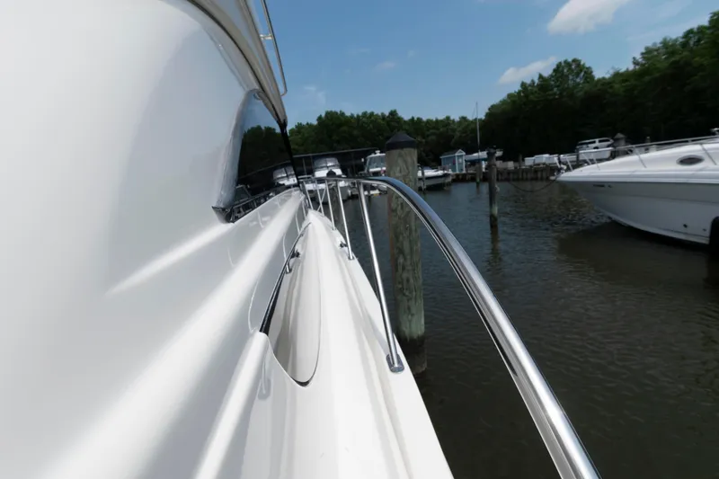 Slide: The Image of 2006 Meridian 341 Sedan yacht docked at marina, side view with railing and water. - 13