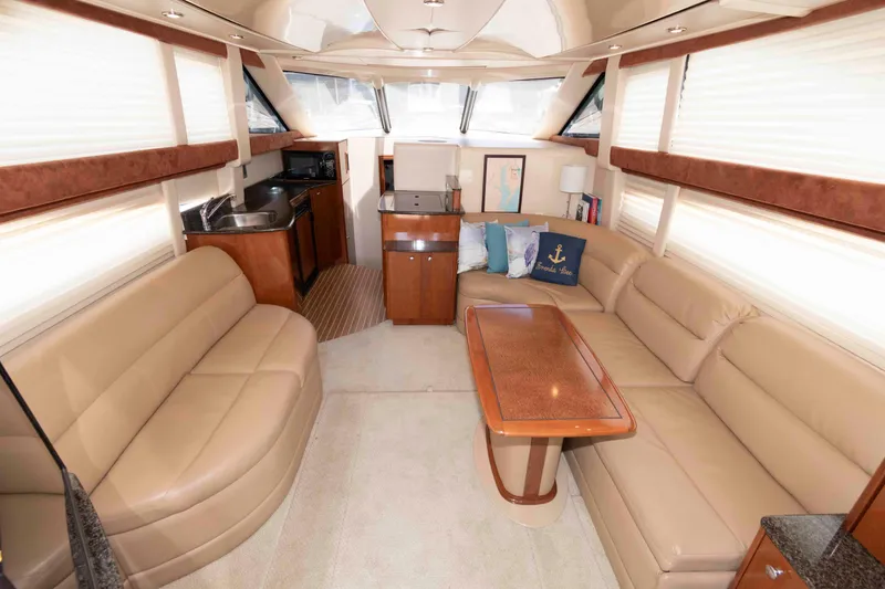 Slide: The Image of Luxurious interior of 2006 Meridian 341 Sedan yacht with beige leather seating and wooden accents. - 14