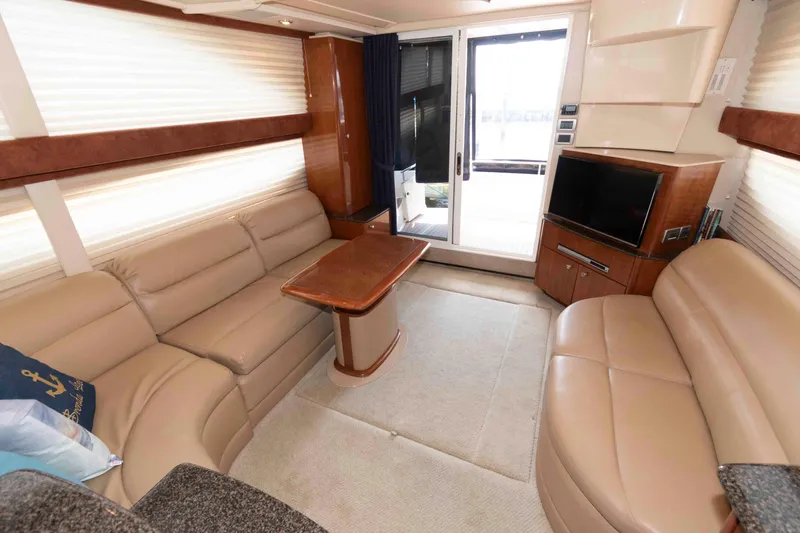 Slide: The Image of Interior of 2006 Meridian 341 Sedan yacht with beige leather seating and wooden accents. - 17