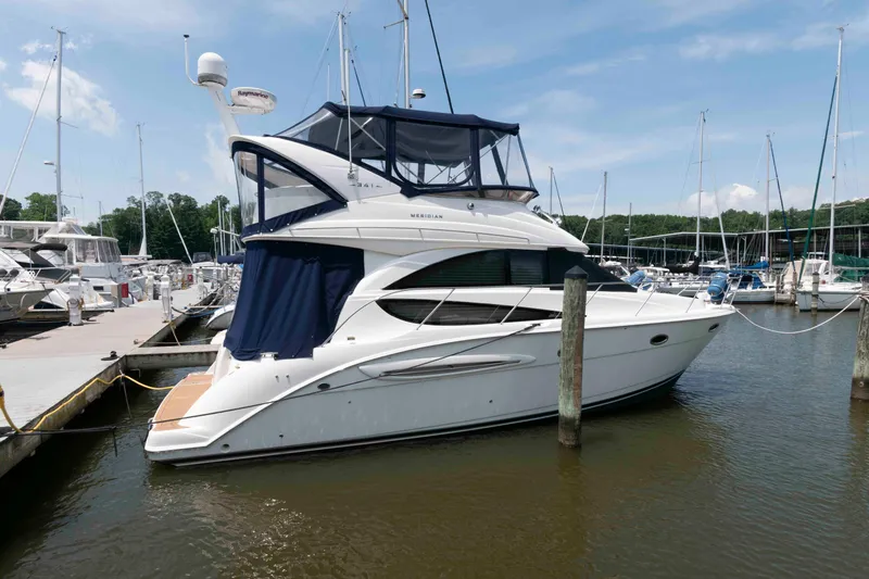 Slide: The Image of 2006 Meridian 341 Sedan yacht docked at a marina under a clear blue sky. - 3