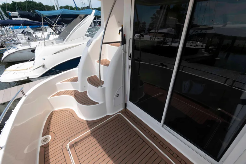 Slide: The Image of 2006 Meridian 341 Sedan yacht deck with wooden flooring and marina view. - 5