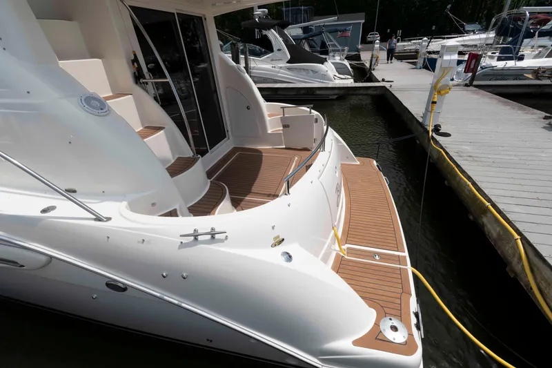 Slide: The Image of 2006 Meridian 341 Sedan yacht docked at marina with wooden deck and sleek design. - 6
