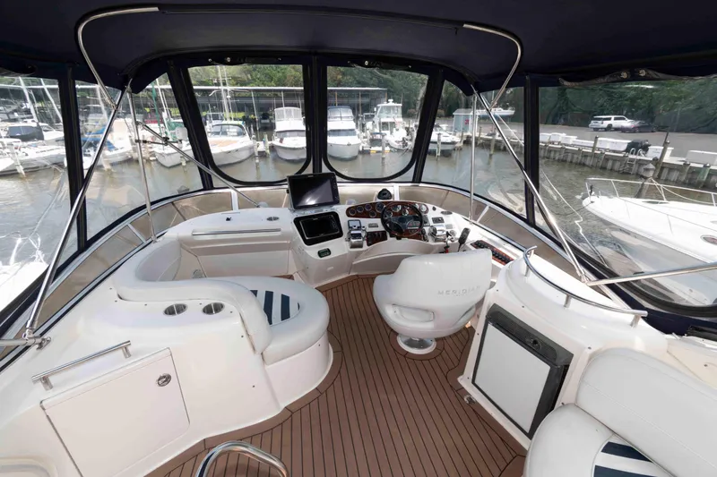 Slide: The Image of Interior view of 2006 Meridian 341 Sedan yacht cockpit with marina backdrop. - 7