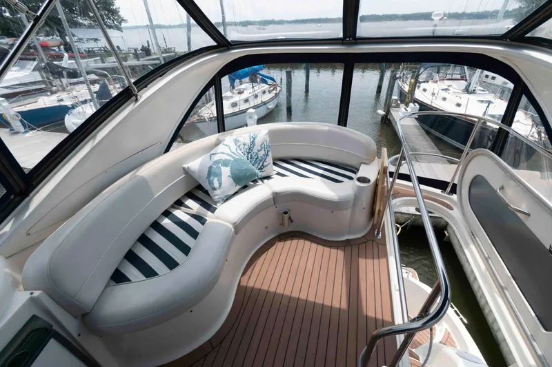 Slide: The Image of Luxurious 2006 Meridian 341 Sedan yacht interior with curved seating and striped cushions. - 8