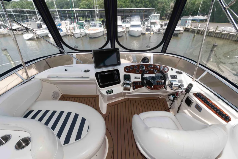 Slide: The Image of Luxurious 2006 Meridian 341 Sedan yacht cockpit with modern navigation equipment and plush seating. - 9