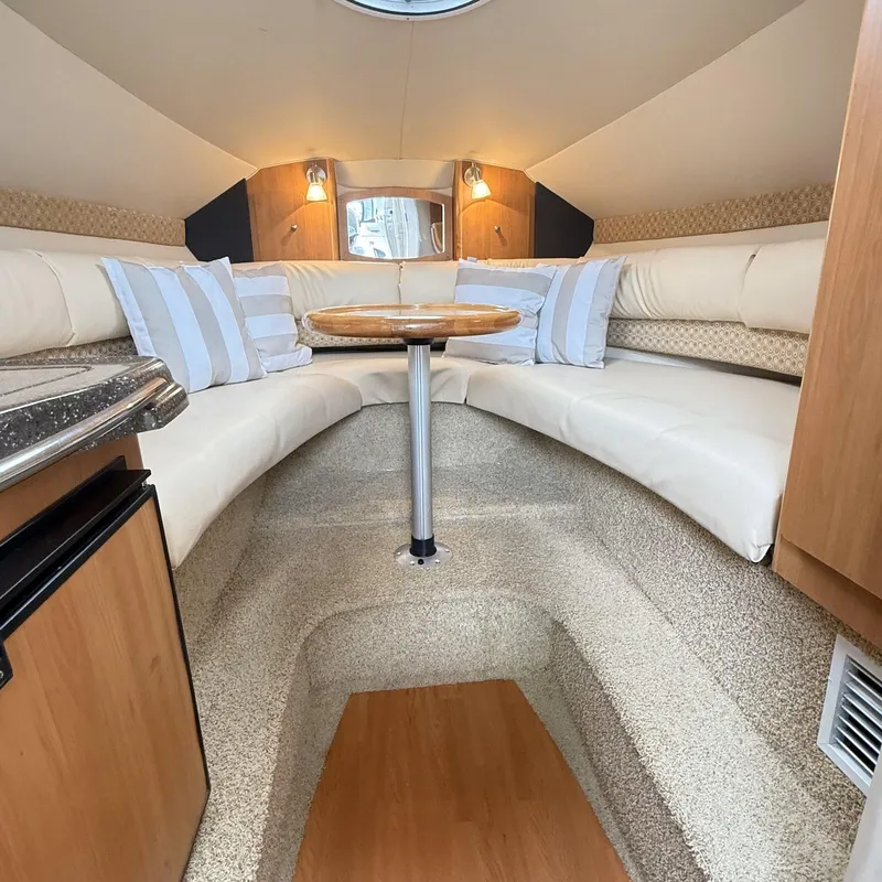 Slide: The Image of Interior of 2010 Glastron GS 289 boat with cozy seating and table. - 11
