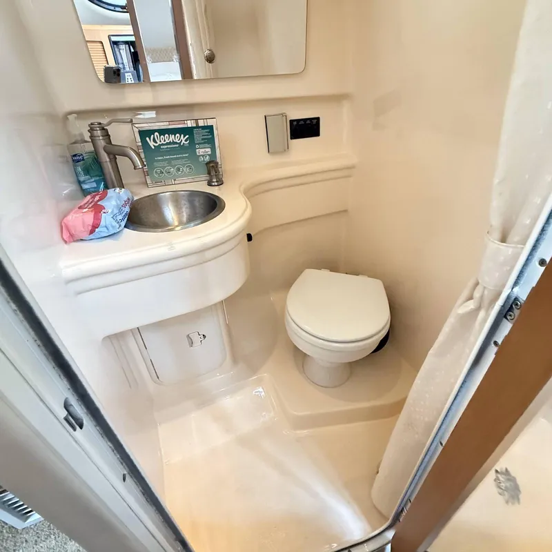 Slide: The Image of Compact bathroom in 2010 Glastron GS 289 boat with sink and toilet. - 18