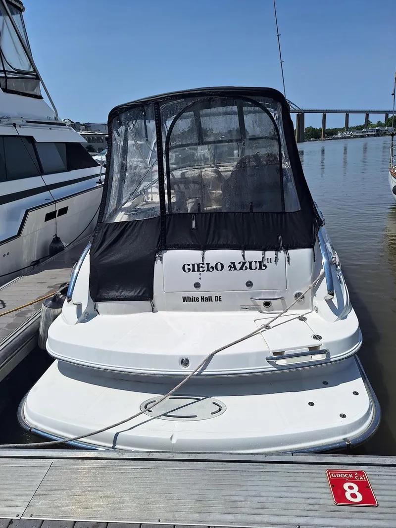 Slide: The Image of 2010 Glastron GS 289 boat docked, featuring a black canopy and "Cielo Azul" name. - 2