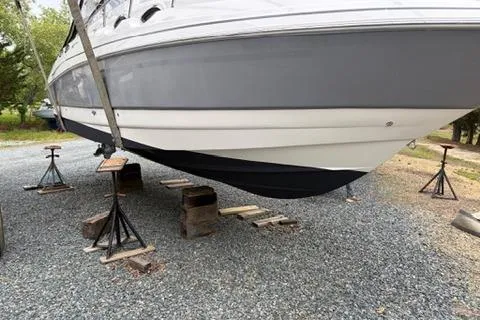 Slide: The Image of 2010 Glastron GS 289 boat on stands, gravel surface, side view. - 21
