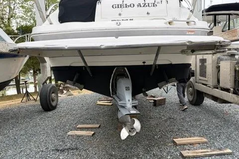 Slide: The Image of 2010 Glastron GS 289 boat on trailer, rear view showing propeller and hull. - 22
