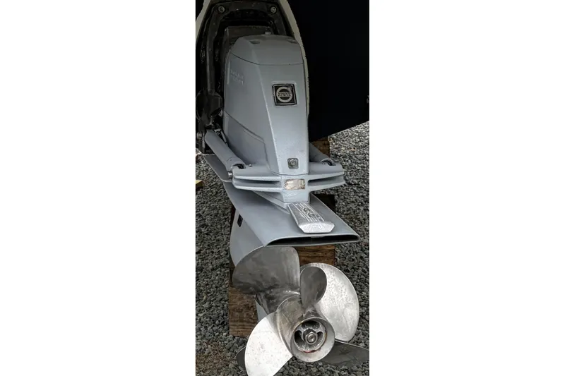 Slide: The Image of 2010 Glastron GS 289 boat engine and propeller on gravel surface. - 23