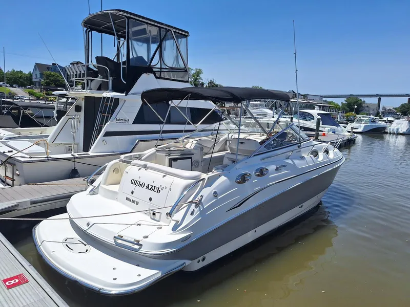 Slide: The Image of 2010 Glastron GS 289 boat docked in marina under clear blue sky. - 4