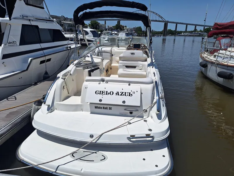 Slide: The Image of 2010 Glastron GS 289 boat docked in marina, with bridge in background. - 7