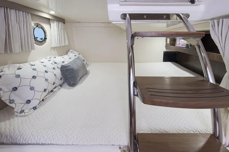 Slide: The Image of 2016 Regal 28 Express cabin interior with bed and wooden steps. - 90