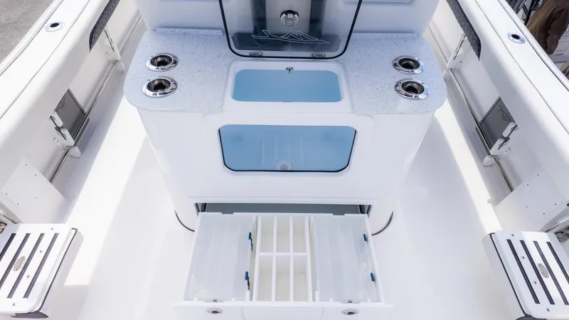 Slide: The Image of 2025 Tidewater 3100 CB boat interior with storage compartments and cup holders. - 13