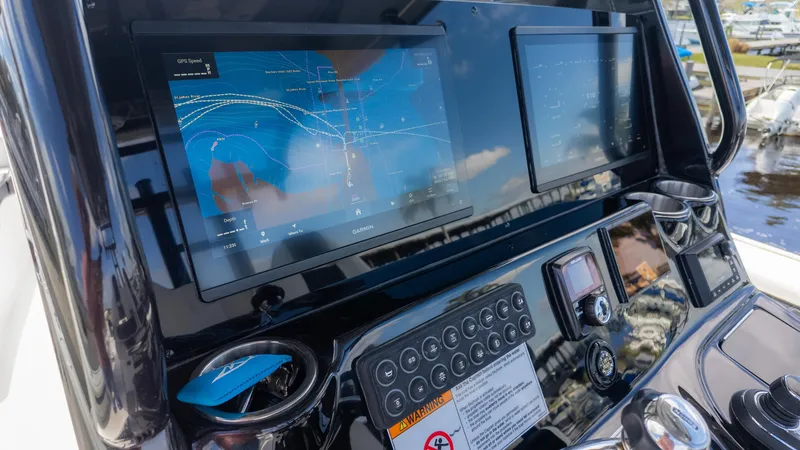 Slide: The Image of Control panel of 2025 Tidewater 3100 CB boat with navigation screens and controls. - 17