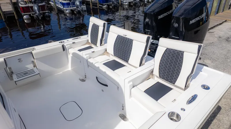 Slide: The Image of 2025 Tidewater 3100 CB boat interior with stylish seating and dual Mercury engines. - 5