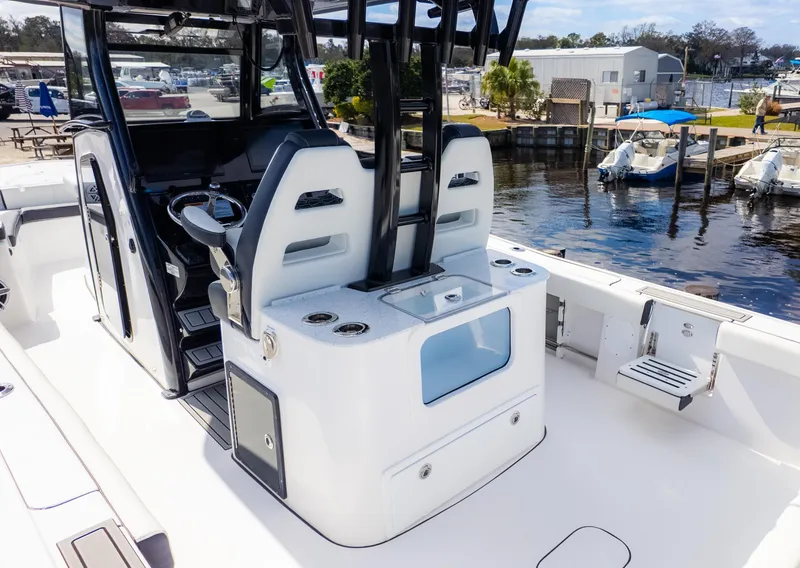 Slide: The Image of 2025 Tidewater 3100 CB boat interior with helm, seating, and waterfront view. - 6