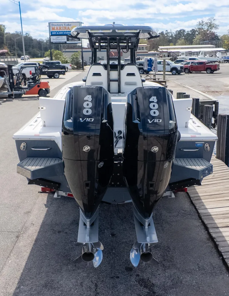Slide: The Image of 2025 Tidewater 3100 CB boat with dual Mercury 400 V10 engines at marina. - 7