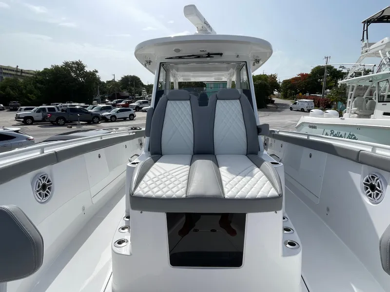Slide: The Image of 2026 Everglades 375cc boat with luxurious seating and sleek design in a marina setting. - 12