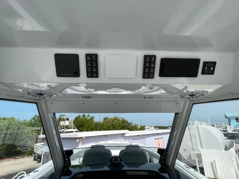 Slide: The Image of Interior view of 2026 Everglades 375cc boat dashboard with control panels and switches. - 27