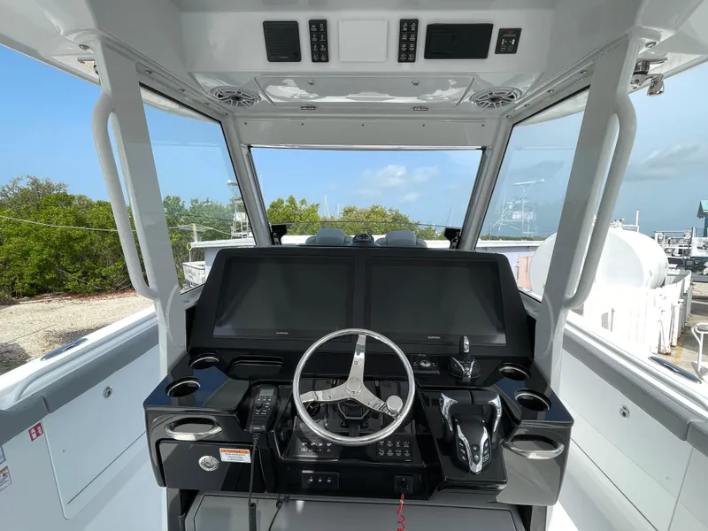Slide: The Image of 2026 Everglades 375cc boat cockpit with advanced navigation system and steering wheel. - 28