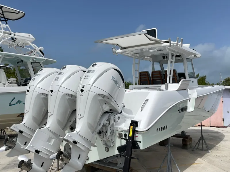 Slide: The Image of 2026 Everglades 375cc boat with triple Yamaha outboard engines, docked on a sunny day. - 3