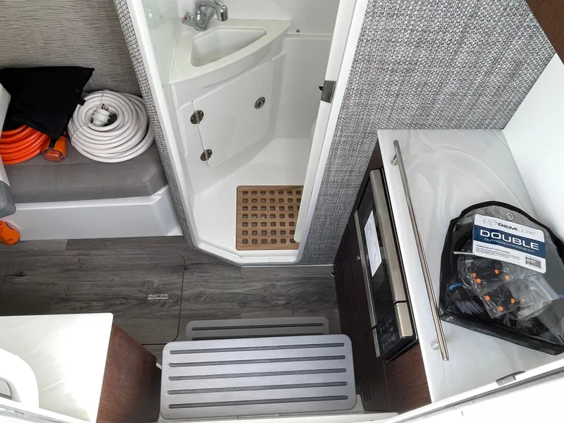Slide: The Image of 2026 Everglades 375cc interior with shower, hoses, and storage space. - 32