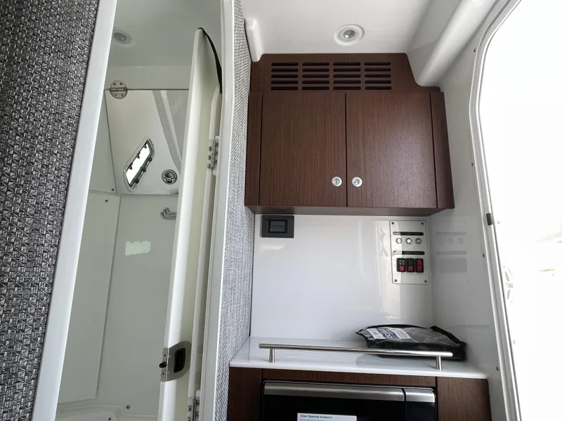 Slide: The Image of Interior of 2026 Everglades 375cc boat with wooden cabinets and modern fixtures. - 33