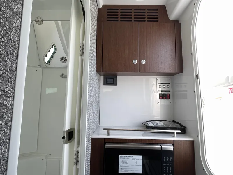 Slide: The Image of Interior of 2026 Everglades 375cc boat with wooden cabinets and modern appliances. - 35