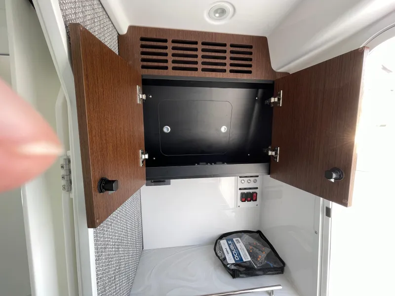 Slide: The Image of Open cabinet in Everglades 375cc boat, 2026 model, with storage and control panel. - 38