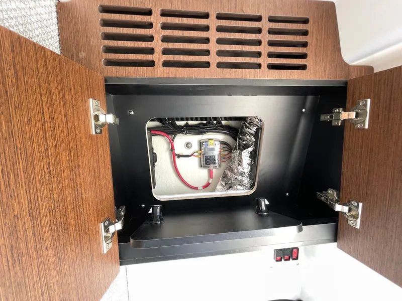 Slide: The Image of Open cabinet showing wiring and components inside Everglades 375cc, 2026 model. - 39