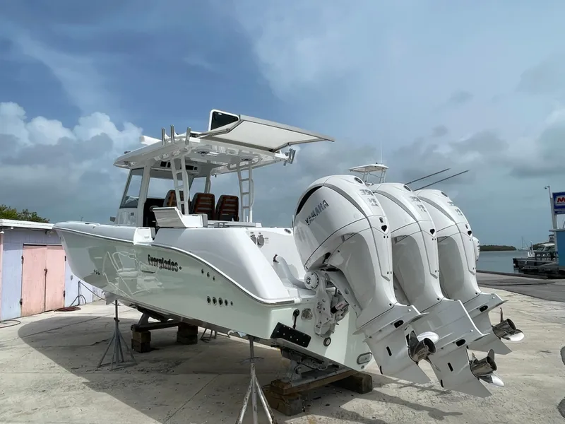 Slide: The Image of 2026 Everglades 375cc boat with triple Yamaha engines on a dock. - 4