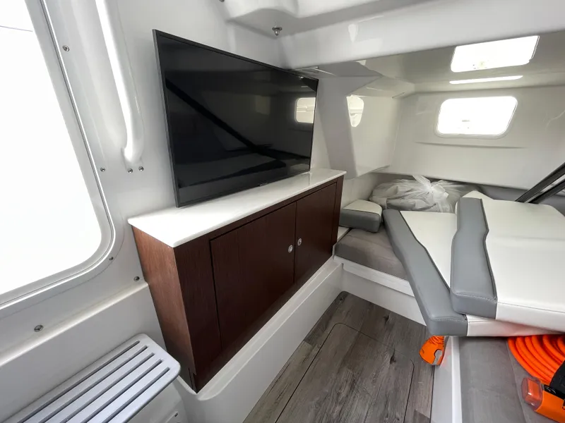 Slide: The Image of Interior of 2026 Everglades 375cc boat with TV, seating, and modern design. - 40