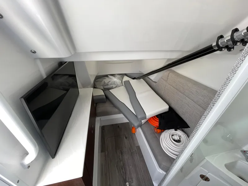Slide: The Image of Interior of 2026 Everglades 375cc boat with seating, TV, and storage. - 41