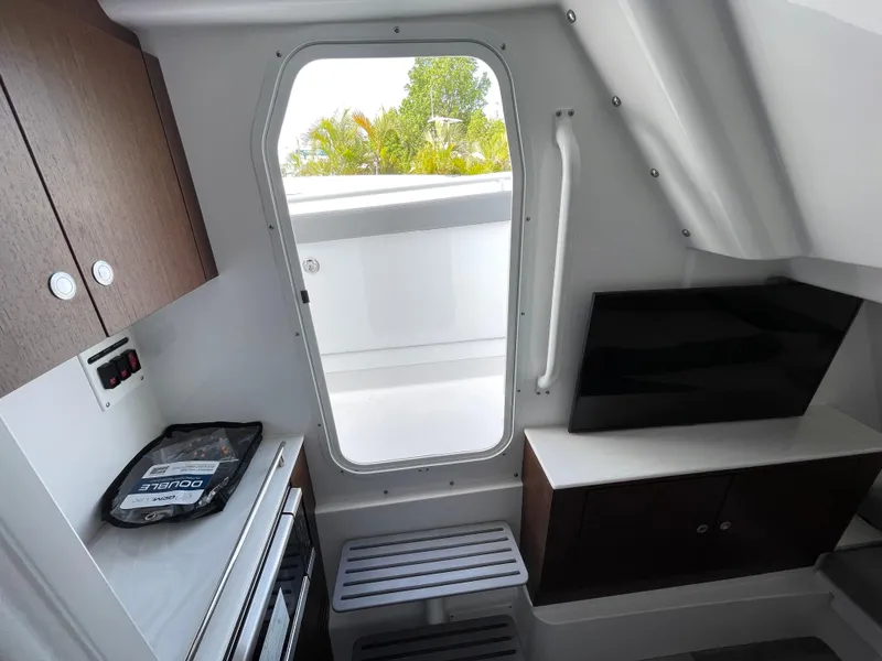 Slide: The Image of Interior of 2026 Everglades 375cc boat with modern cabinetry and sleek design. - 42