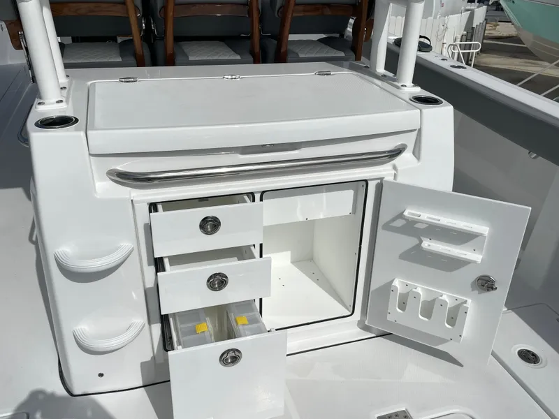 Slide: The Image of Open storage compartments on a 2026 Everglades 375cc boat, showcasing drawers and shelves. - 46