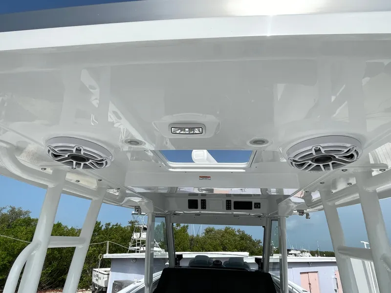 Slide: The Image of 2026 Everglades 375cc boat interior with speakers and skylight, showcasing modern design. - 48