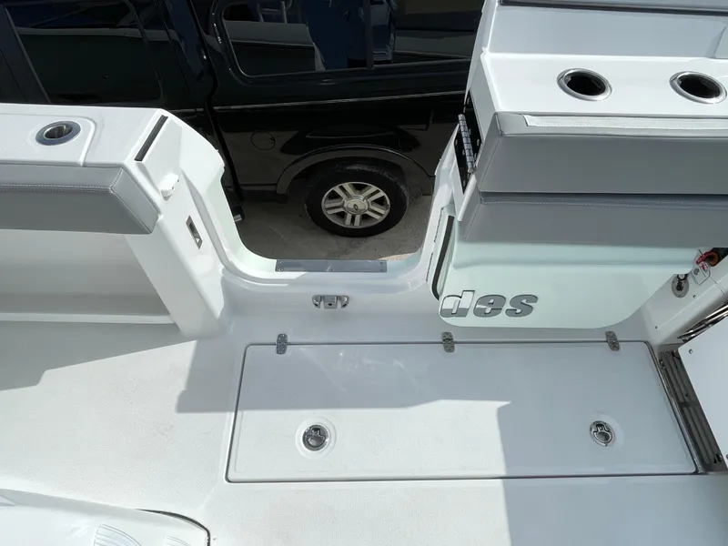Slide: The Image of 2026 Everglades 375cc boat deck with storage compartments and cup holders. - 49