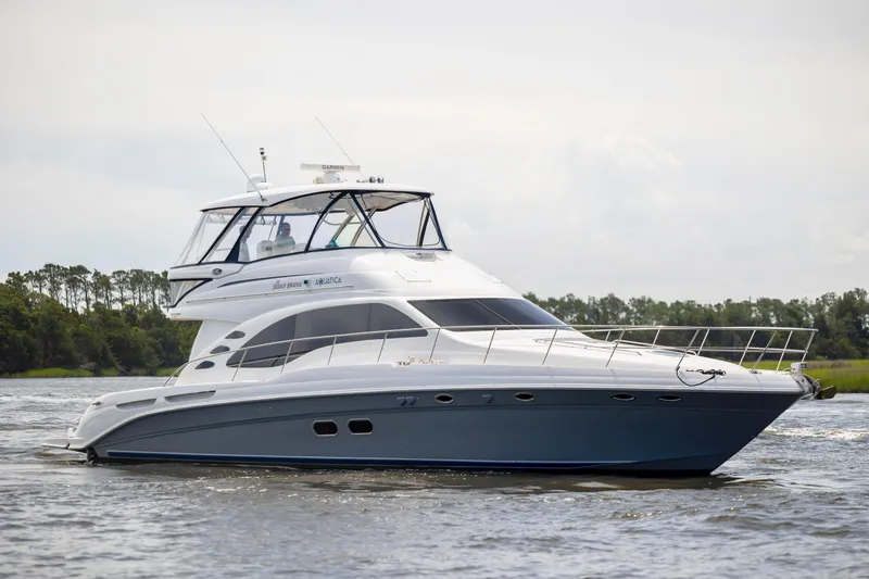 Slide: The Image of 2008 Sea Ray 58 Sedan Bridge yacht cruising on a calm river. - 10