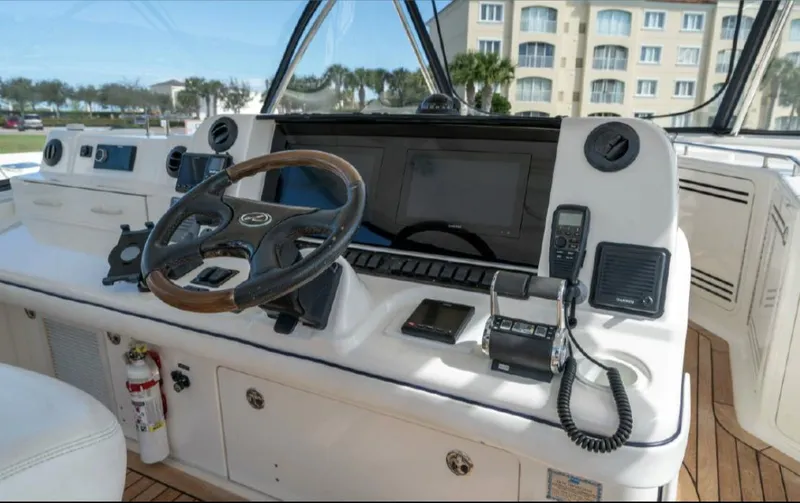 Slide: The Image of 2008 Sea Ray 58 Sedan Bridge helm with steering wheel and navigation equipment. - 15