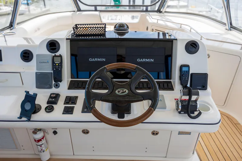 Slide: The Image of 2008 Sea Ray 58 Sedan Bridge helm with Garmin navigation and wooden steering wheel. - 16